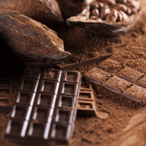 Chocolate bar, candy sweet, cacao beans and powder on wooden background